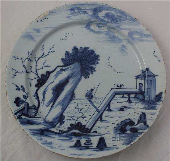 Two English delft ware chargers, 33.5cm and 34.5cm, latter with small area of restoration